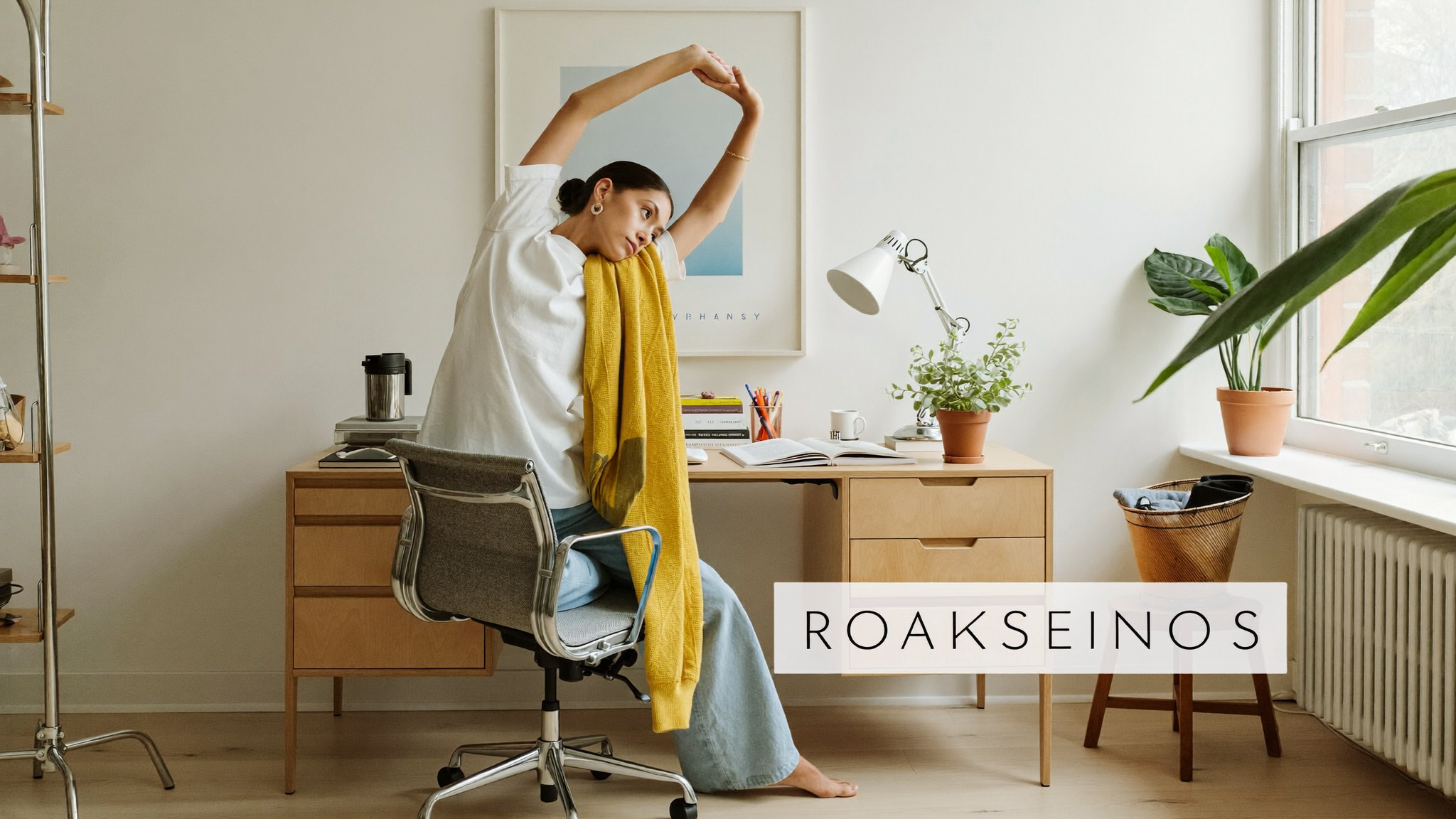 A woman stretching her back beside a bright home desk